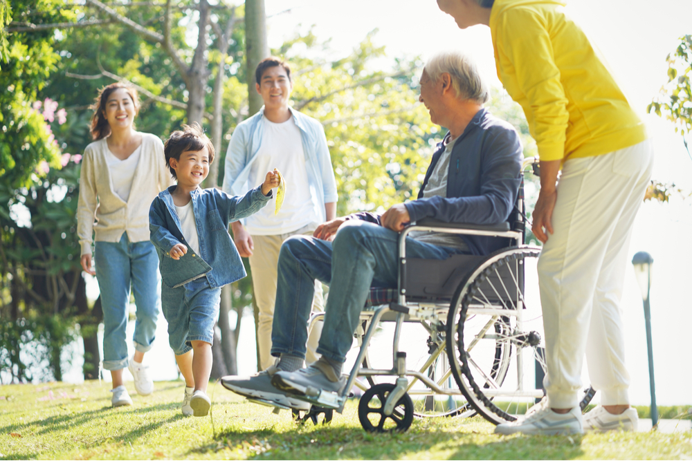 Asian family visiting assisted living resident