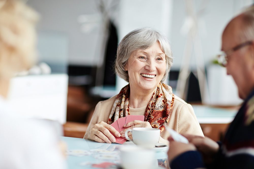 Older woman in assisted living enjoying activities and socialization