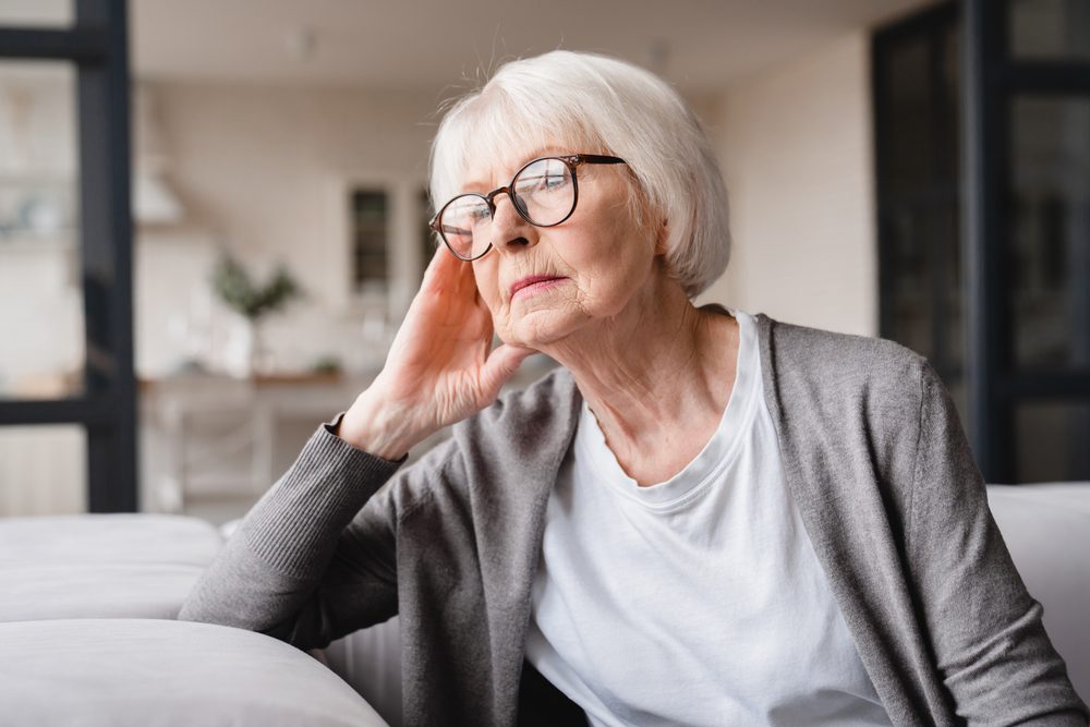 Senior woman looking out window