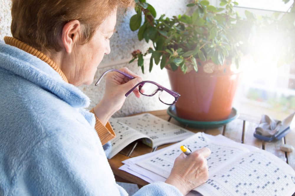 Woman doing crossword puzzle